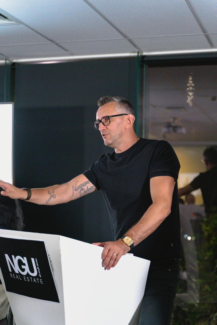Emil Juresic presenting at the NGU lectern in the Milton HQ conference room